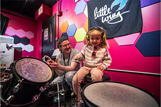 School of Rock after-school student learning drums in our Little Wing program