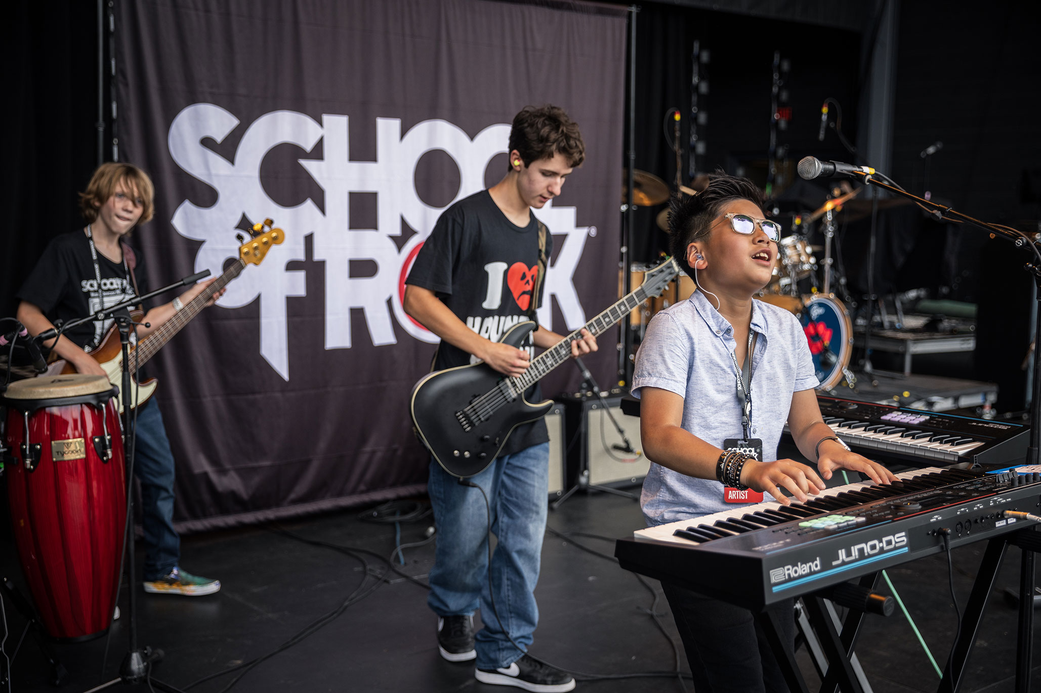 A School of Rock student playing keyboard in a rock band