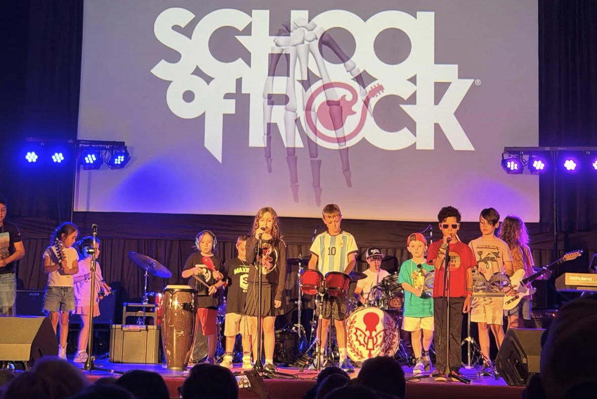 Young students ages 7 to 9 performing live rock music on stage at School of Rock Huntington