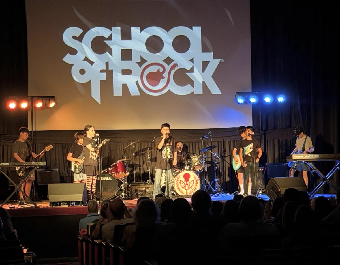 Students ages 10 to 12 performing Hair Metal on stage at School of Rock Huntington's Spring 2026 Showcase