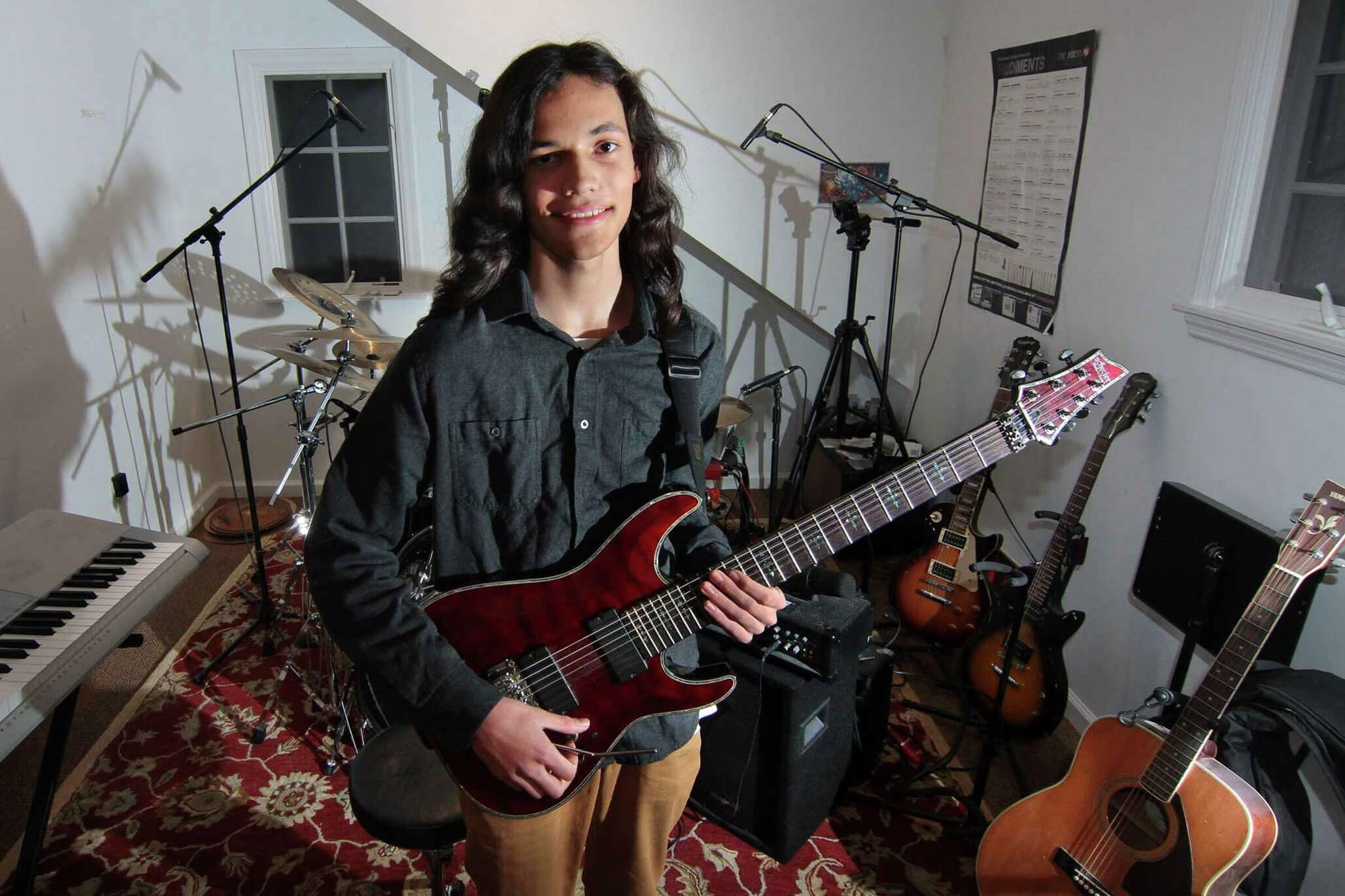 Musician Nikhil Talwalkar, 17, poses in his home studio in Darien, Connecticut