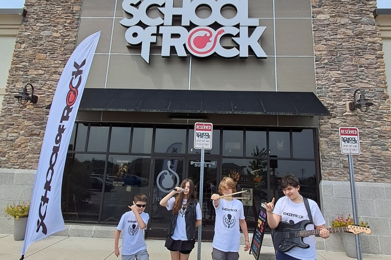 Students from School of Rock York 2025 Summer Camp season pose outside the school
