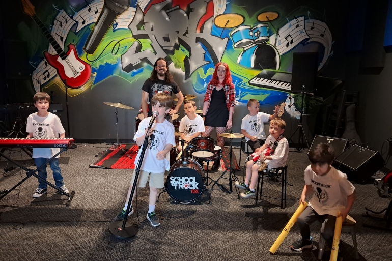 Students from School of Rock York 2025 Summer Camp season pose with their teachers