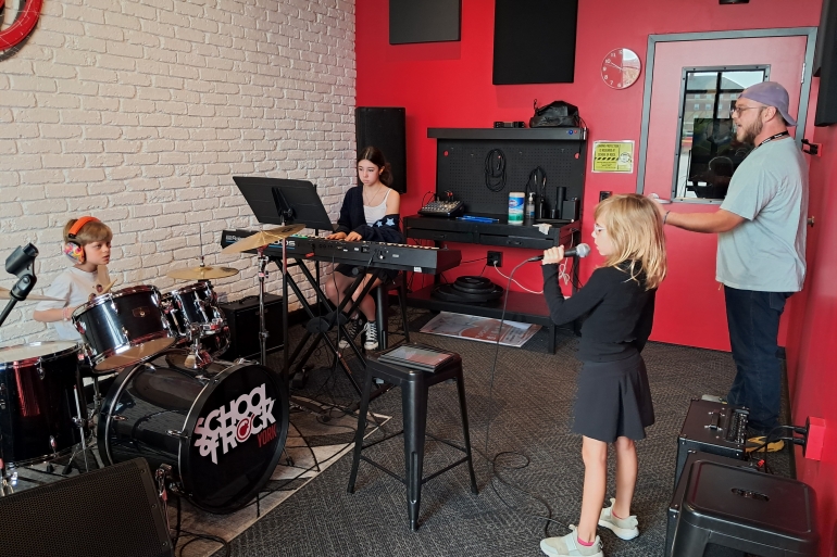 Students from School of Rock York 2025 Summer Camp season practice in one of our band rooms
