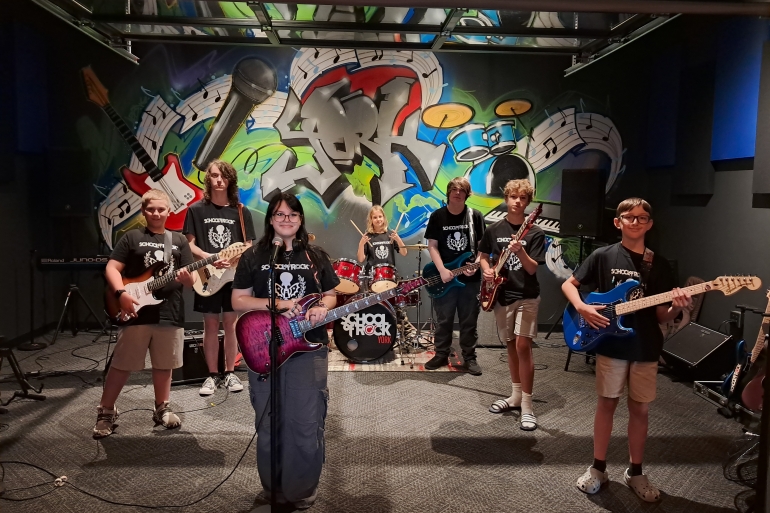 Students from School of Rock York 2025 Summer Camp season pose during a performance