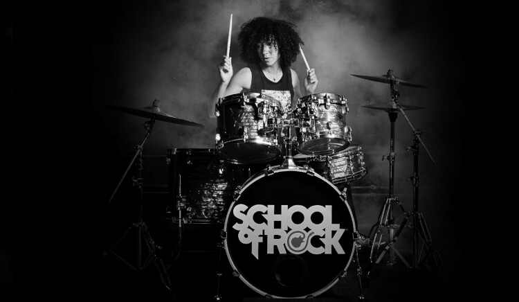 Student taking drum lessons at School of Rock