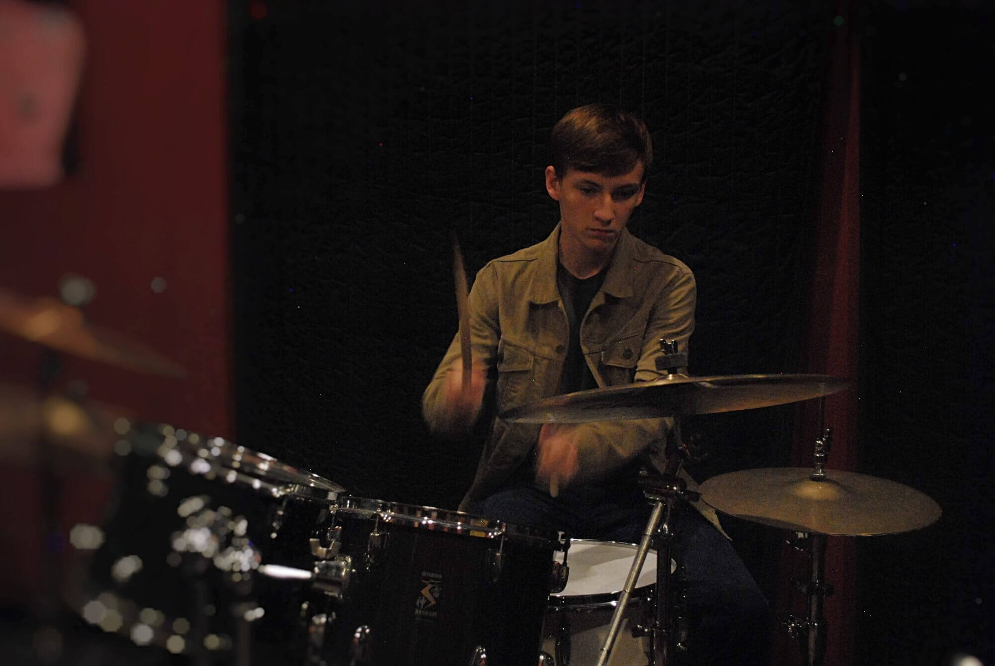 A Katy House Band student works on his drum fills during rehearsal.