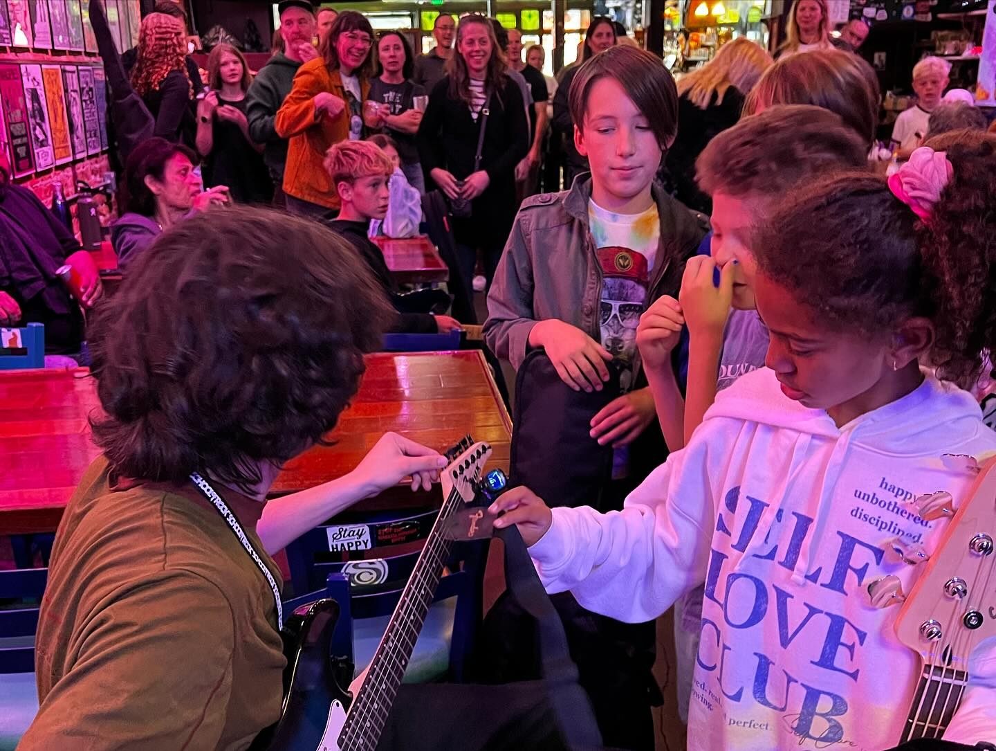 Michael tuning guitars for his Rock 101 group prior to showtime at the Central