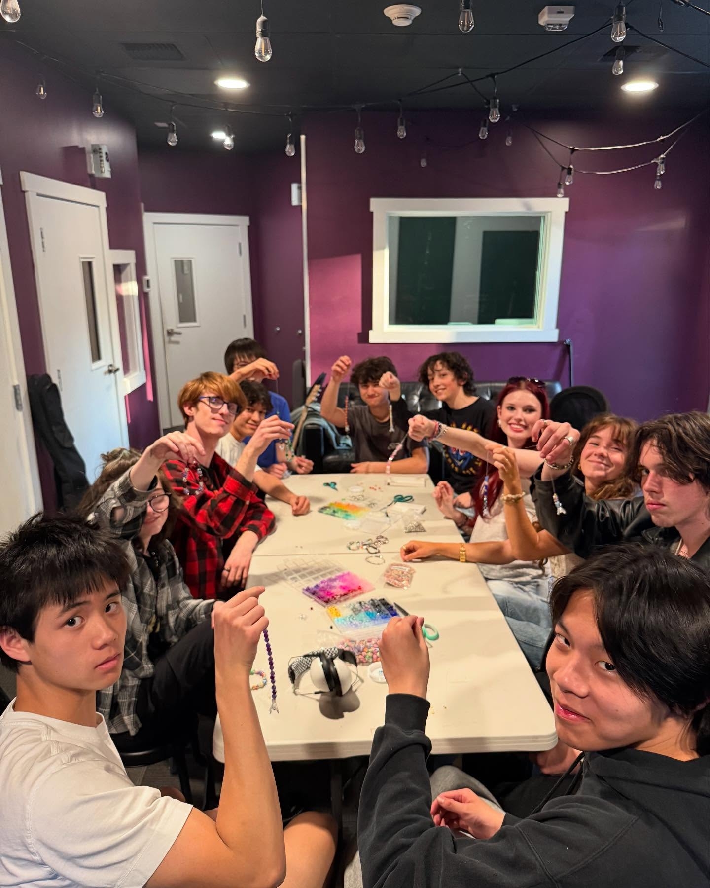 House Band making bracelets to sell for a fundraiser to Summerfest