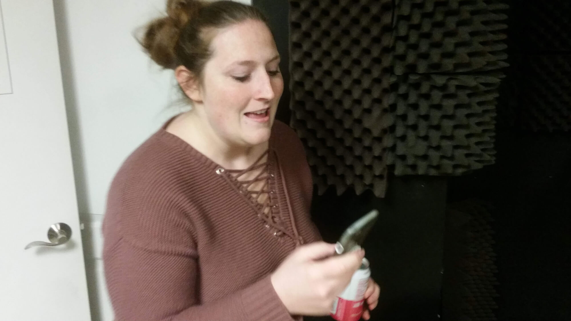 One of our students rehearses lyrics off her phone.