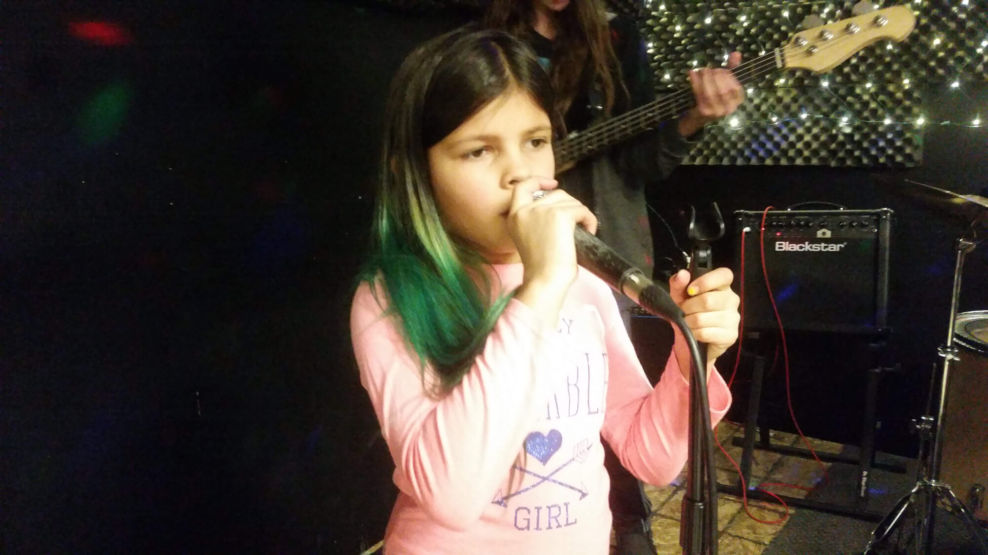 One of our students practicing her vocals during rehearsal.
