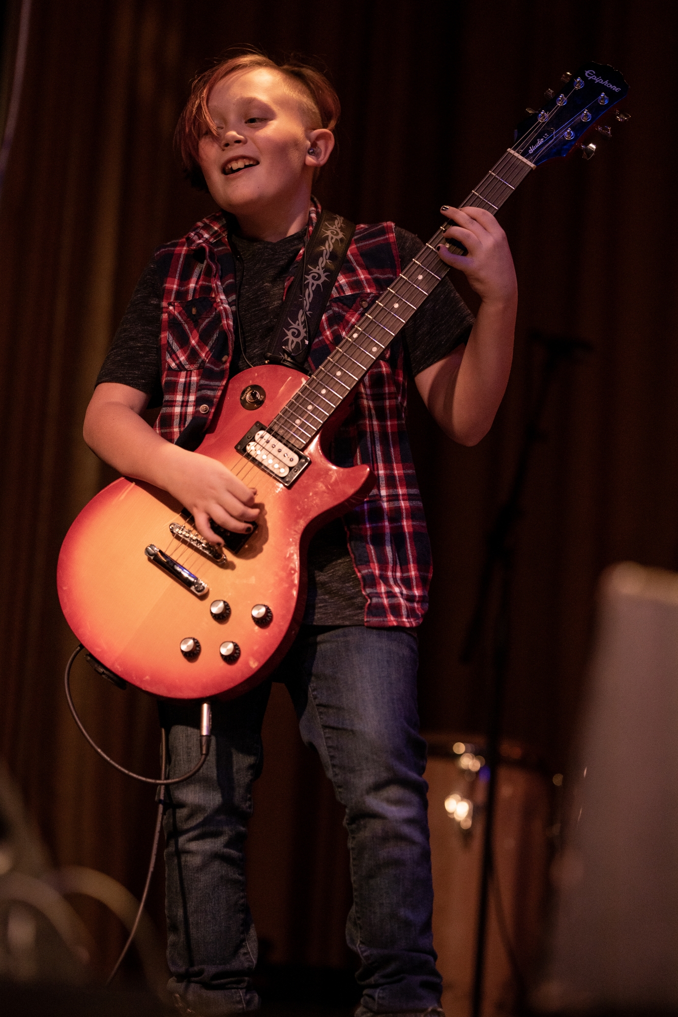 School of Rock student performs on stage.