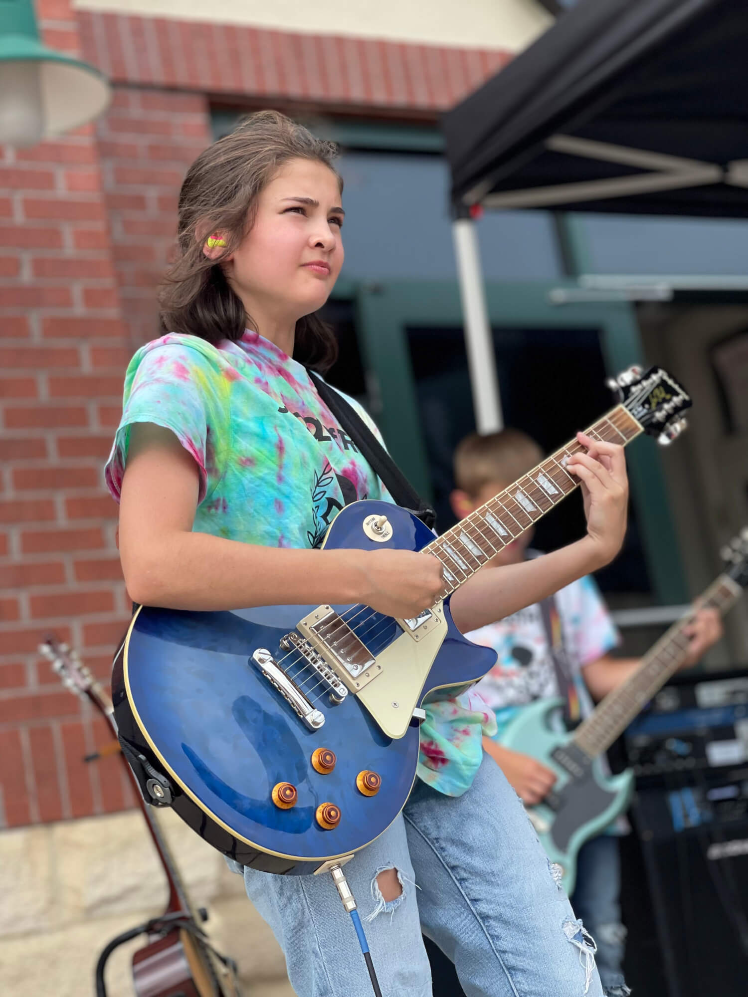 Student performing and playing guitar