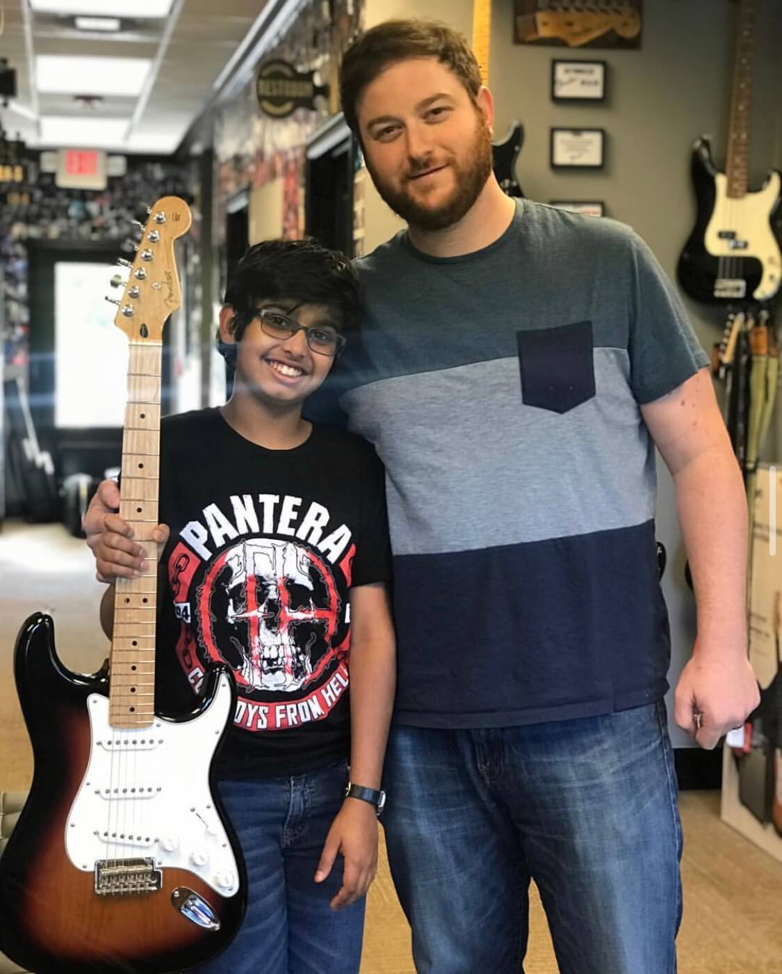 Adam and a student show off his sweet new Fender guitar.