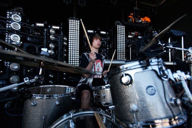 teenage boy playing the drums
