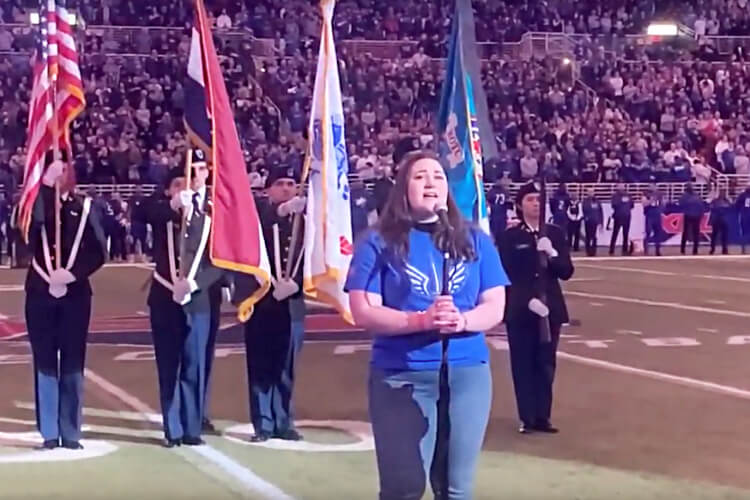 School of Rock student singing National Anthem at XFL game