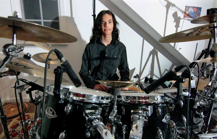 Musician Nikhil Talwalkar, 17, poses in his home studio in Darien, Connecticut