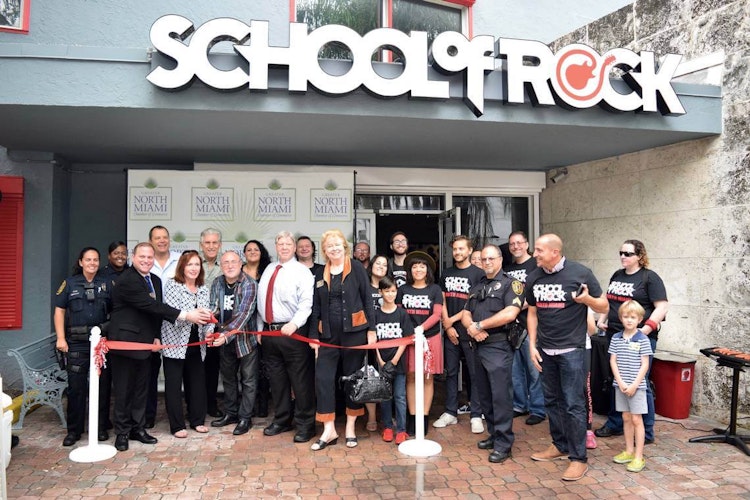 Owners and staff pose in front of the new North Miami location.