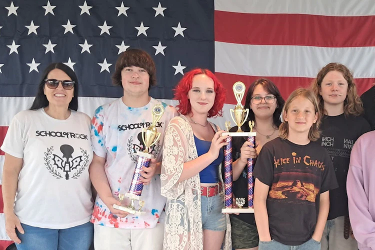 School of Rock York's House Band holding both trophies.