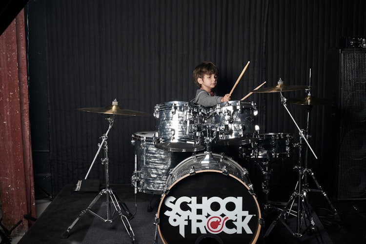 School of Rock student hitting a cymbal with a drum stick