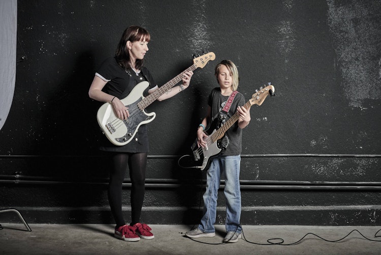 Teacher and student with bass guitars