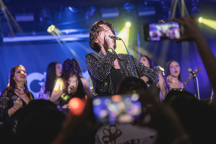 Students performing on stage at a School of Rock show