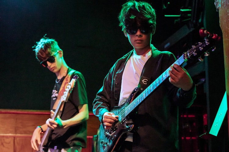 Bassist & Guitar player wearing sunglasses