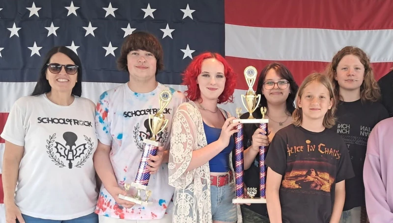 School of Rock York's House Band holding both trophies.