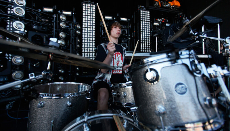 teenage boy playing the drums