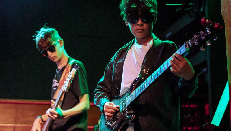 Bassist & Guitar player wearing sunglasses