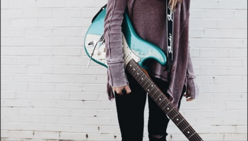 Girl Holding an Electric Guitar 