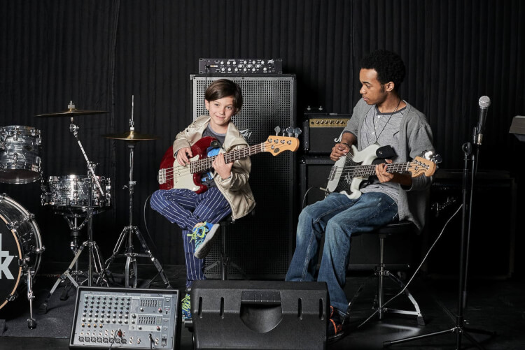 Student learning to play in rock programs for kids