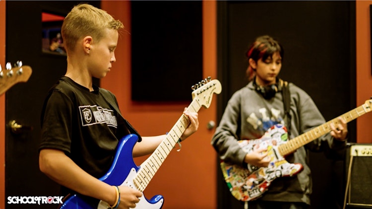 Students smiling in the rock 101 music program 